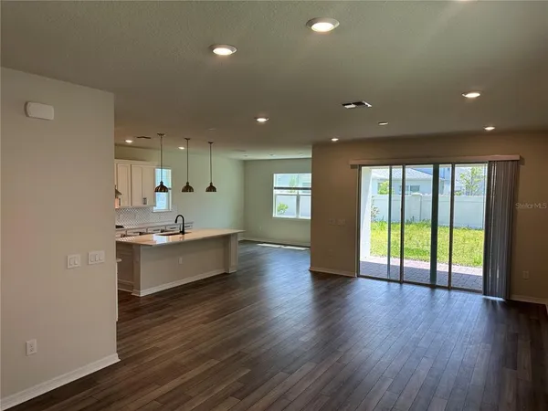 a view of a room with wooden floor and a window