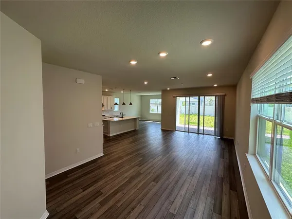 a large kitchen with stainless steel appliances kitchen island a stove a refrigerator a sink dishwasher and a oven with cabinets
