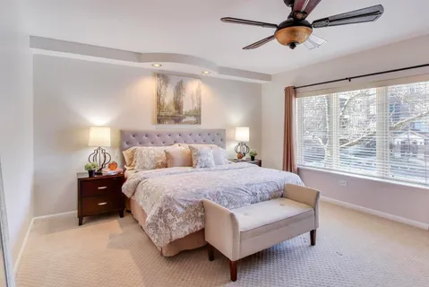 a living room with a bed furniture and a window