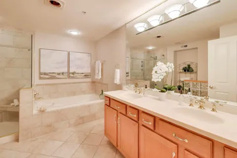 a bathroom with a tub sink and mirror