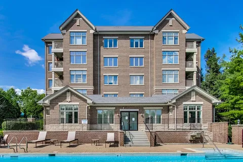 a view of a house with swimming pool and sitting area