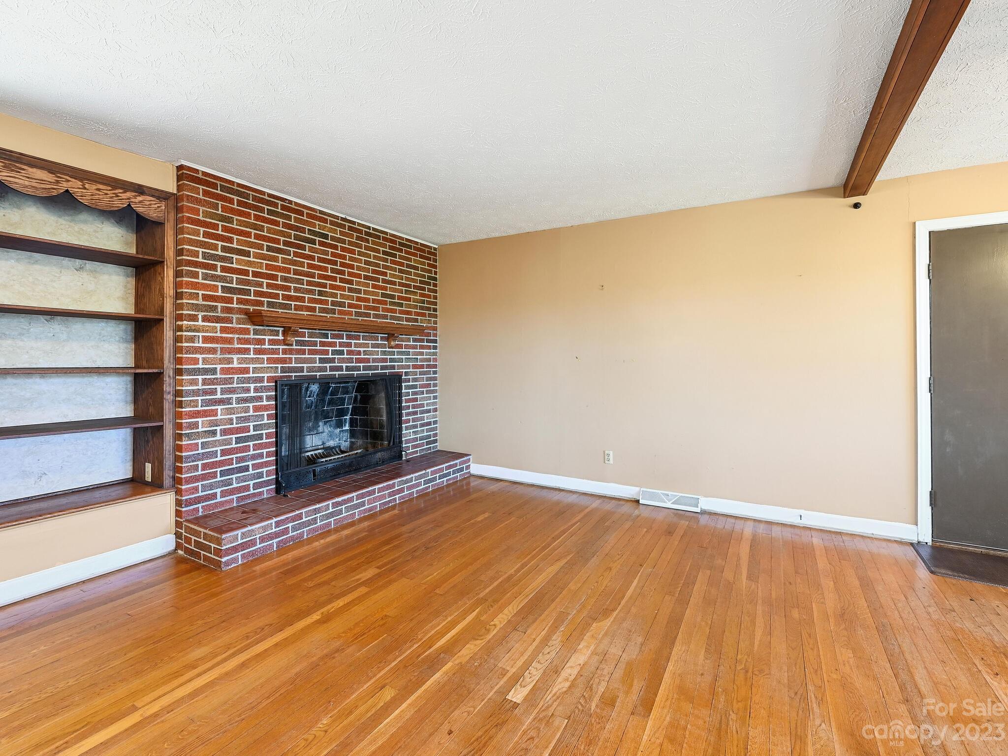 146 Old Road Marshall, NC 28753 - Photo 12 of 31 a view of empty room with wooden floor and fireplace