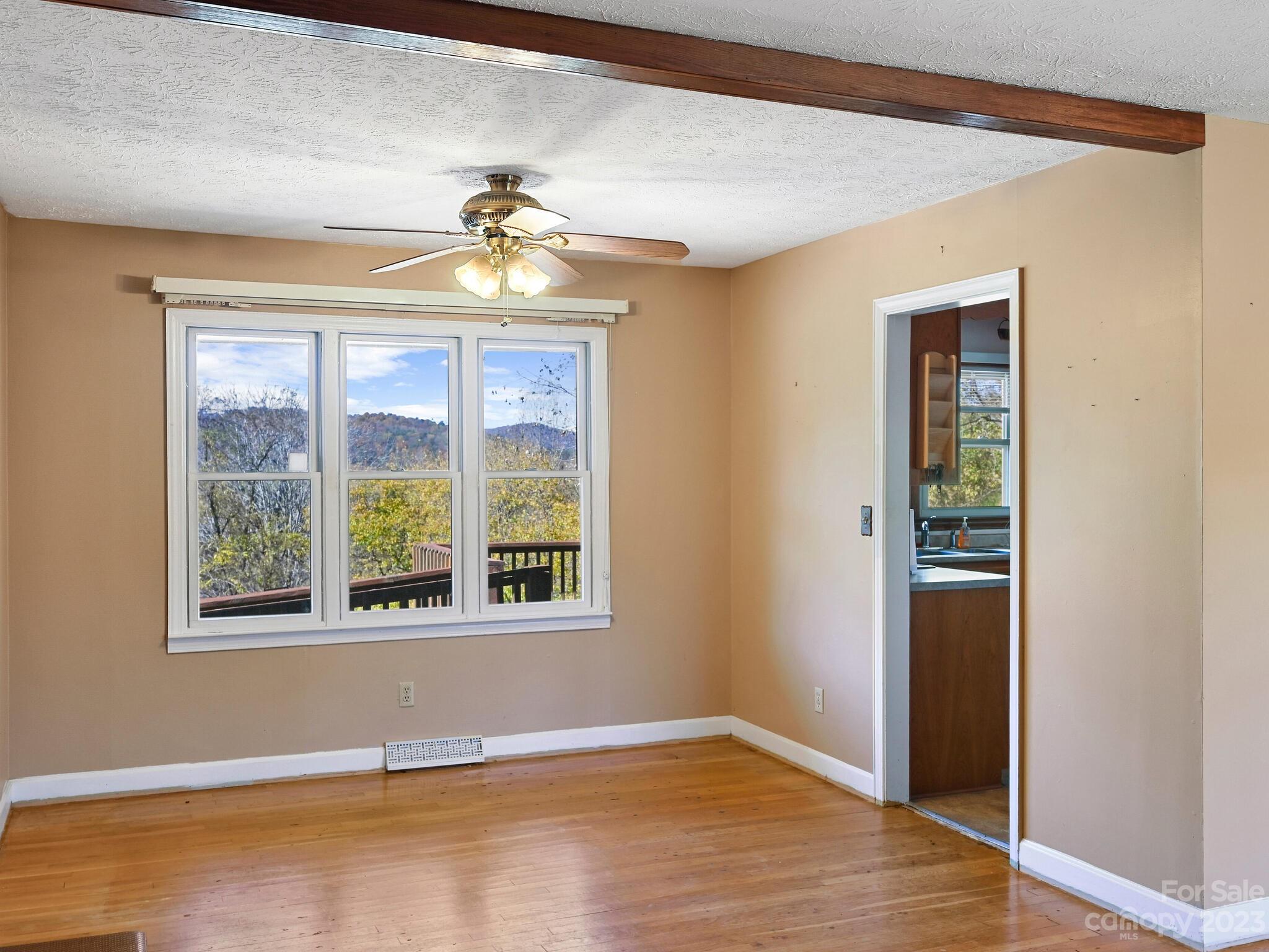 146 Old Road Marshall, NC 28753 - Photo 14 of 31 an empty room with wooden floor and windows