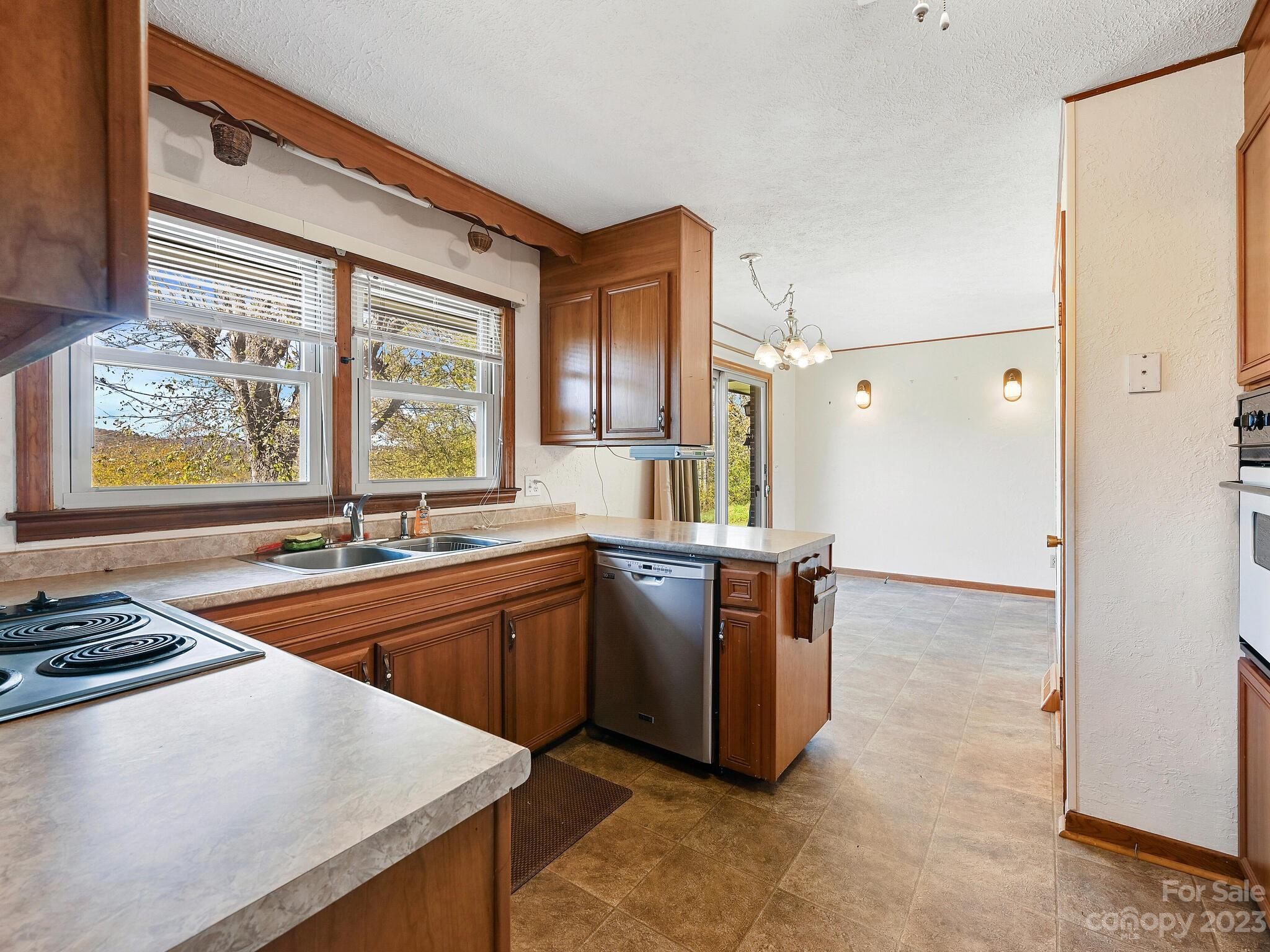 146 Old Road Marshall, NC 28753 - Photo 15 of 31 a kitchen with stainless steel appliances granite countertop a sink stove and refrigerator