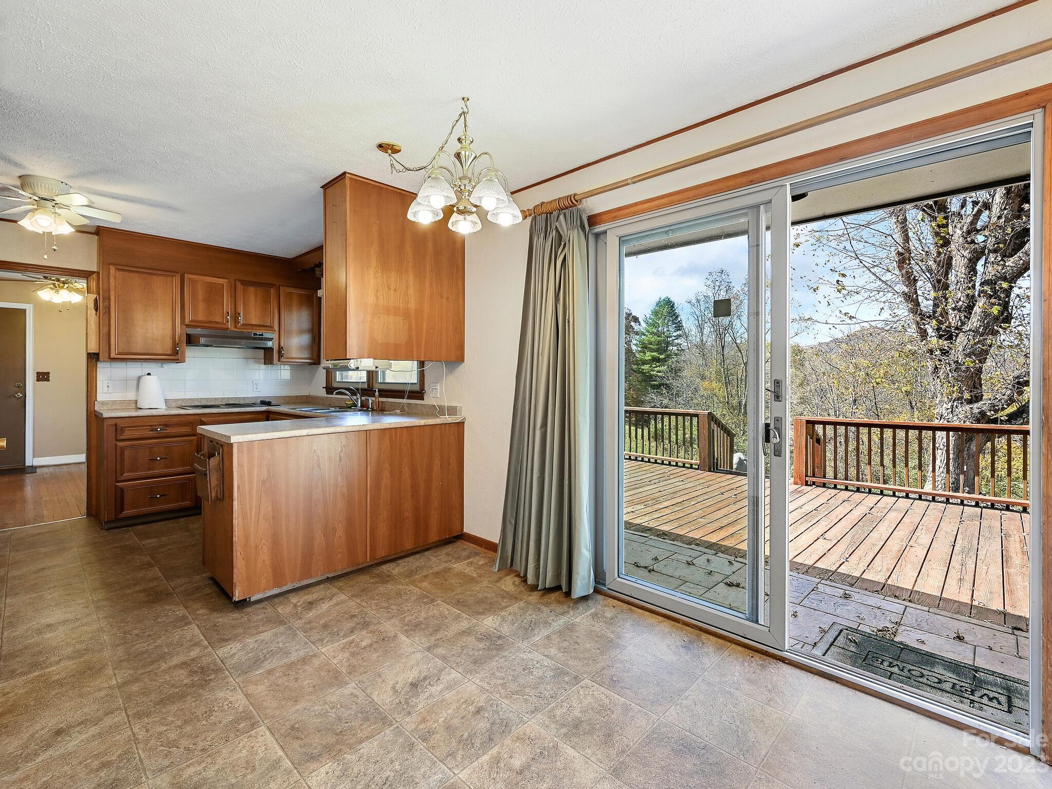 146 Old Road Marshall, NC 28753 - Photo 16 of 31 a kitchen with stainless steel appliances granite countertop a stove a sink and a refrigerator with wooden floor