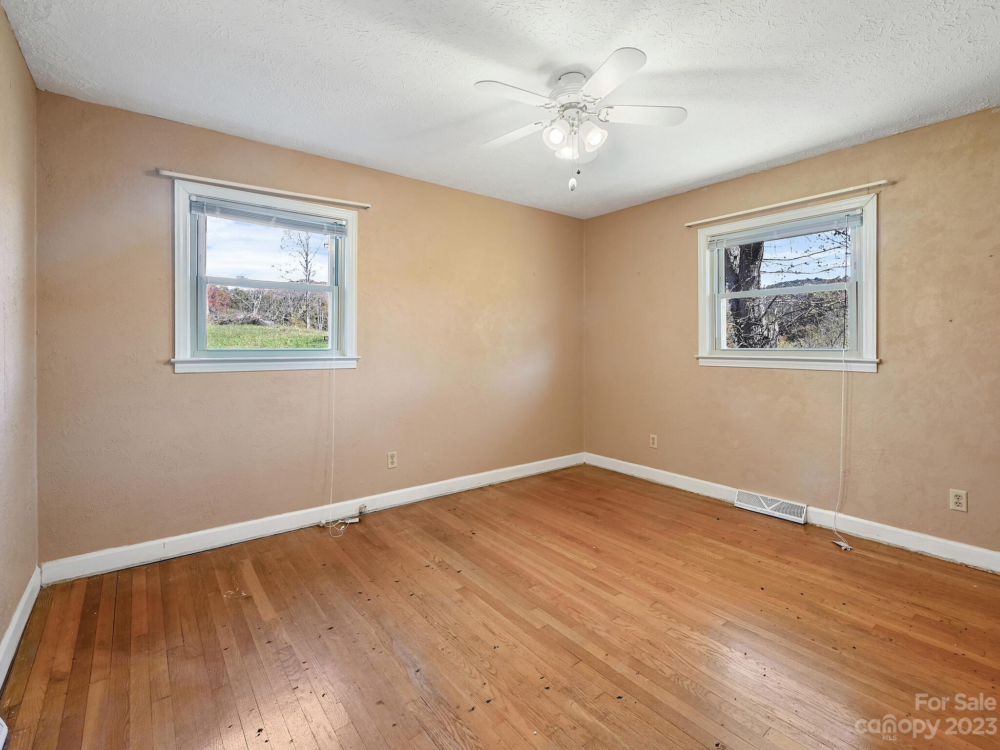146 Old Road Marshall, NC 28753 - Photo 19 of 31 a view of an empty room with wooden floor and a window