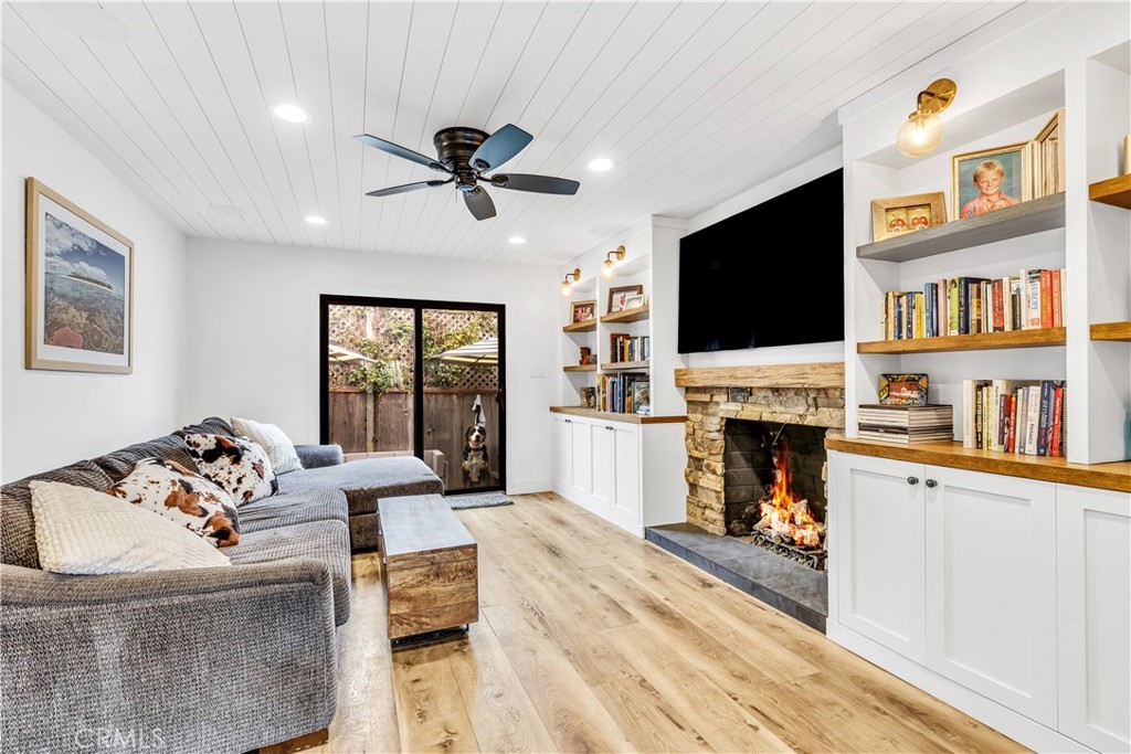 126 Avenida San Dimas San Clemente, CA 92672 - Photo 14 of 34 a living room with furniture a fireplace and a flat screen tv