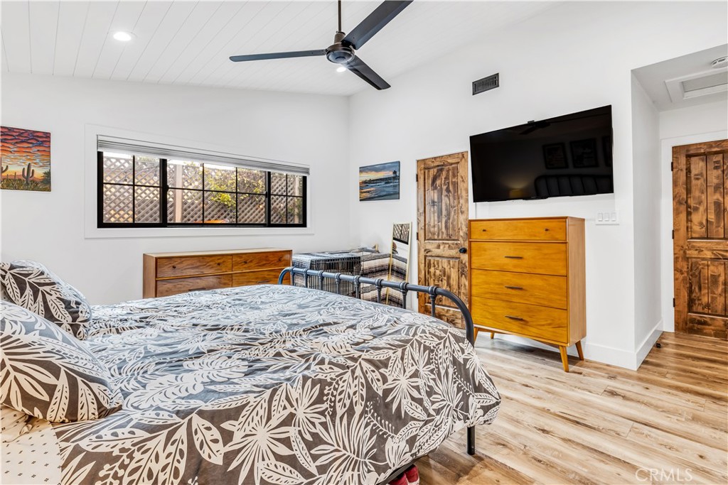 126 Avenida San Dimas San Clemente, CA 92672 - Photo 17 of 34 a bedroom with a bed and wooden floor
