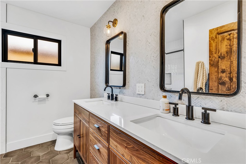 126 Avenida San Dimas San Clemente, CA 92672 - Photo 23 of 34 a bathroom with a double vanity sink mirror and toilet