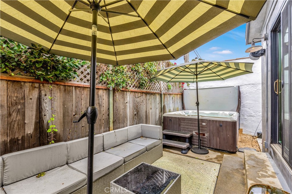 126 Avenida San Dimas San Clemente, CA 92672 - Photo 31 of 34 a backyard of a house with table and chairs under an umbrella