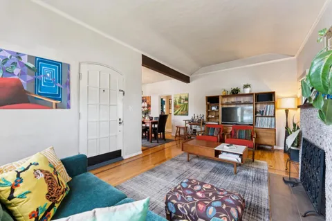 a kitchen with stainless steel appliances granite countertop stove a sink dishwasher a refrigerator and wooden cabinets with wooden floor