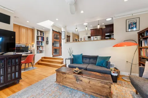 a bedroom with a bed and a chair