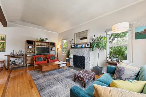 a living room with furniture a table and a chandelier