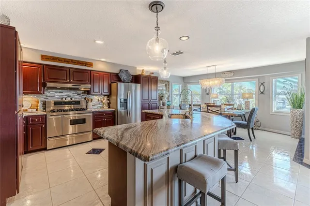 a large kitchen with lots of counter and chairs