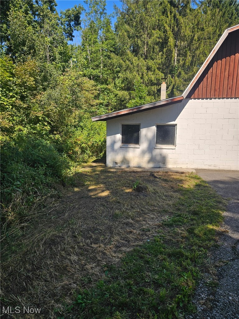 6171 Barrett Road Geneva, OH 44041 - Photo 3 of 38 View of property exterior featuring concrete block siding