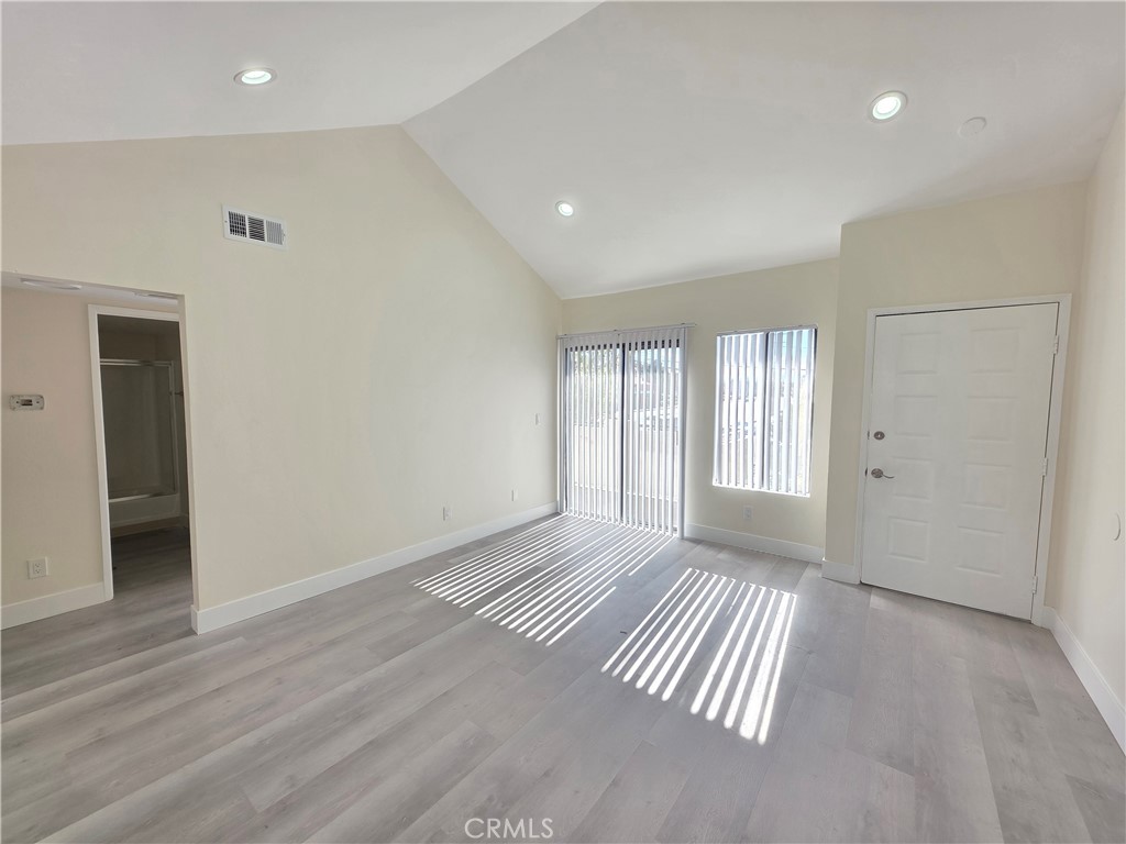 44155 10th Lancaster, CA 93534 - Photo 1 of 14 an empty room with wooden floor and windows
