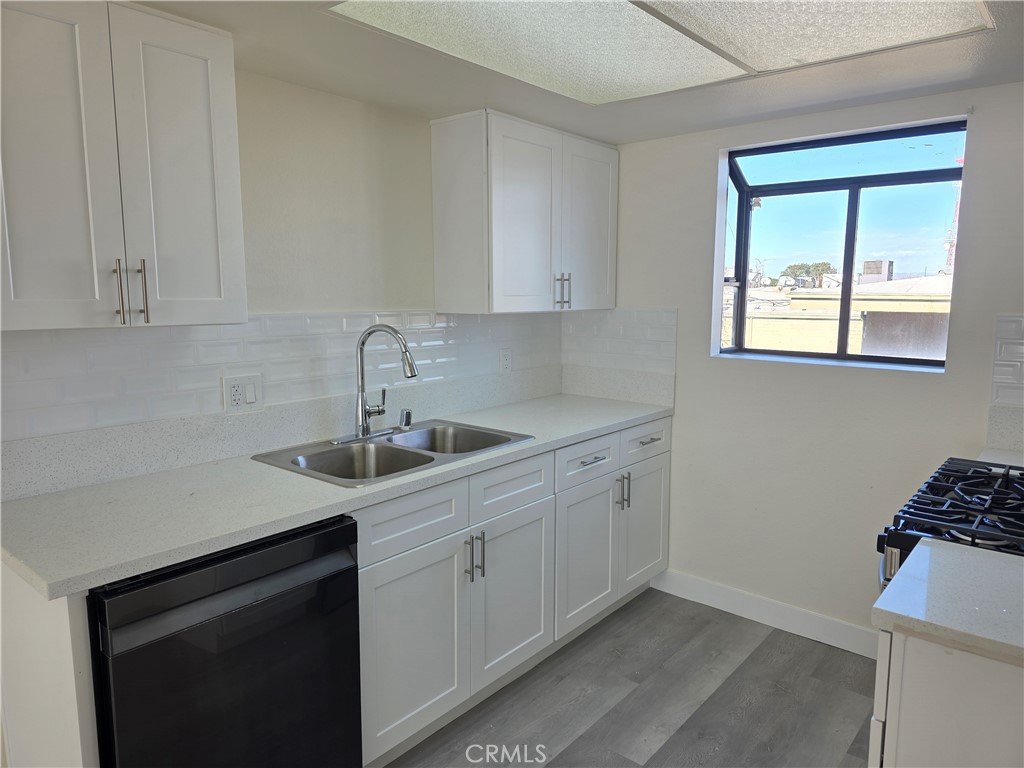 44155 10th Lancaster, CA 93534 - Photo 2 of 14 a kitchen with a sink cabinets and window