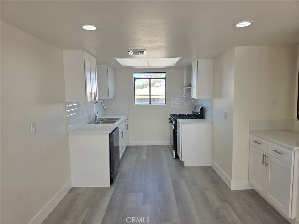 44155 10th Lancaster, CA 93534 - Photo 3 of 14 a room with a sink a washer and dryer