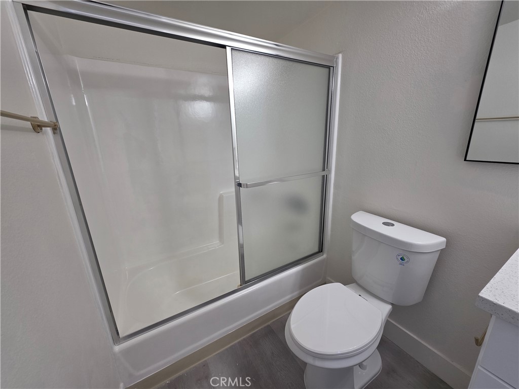 44155 10th Lancaster, CA 93534 - Photo 9 of 14 a white toilet sitting next to a shower
