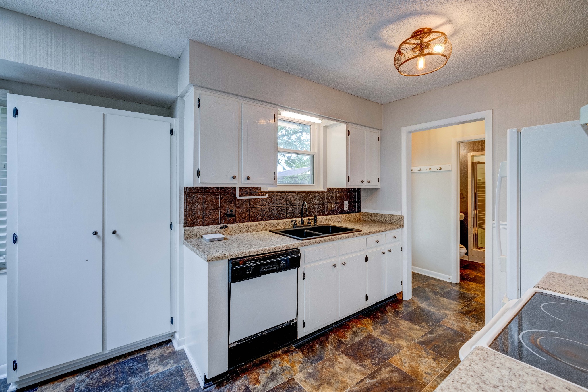 3312 Country Way Road Antioch, TN 37013 - Photo 8 of 35 a kitchen with a stove a sink a refrigerator and a window