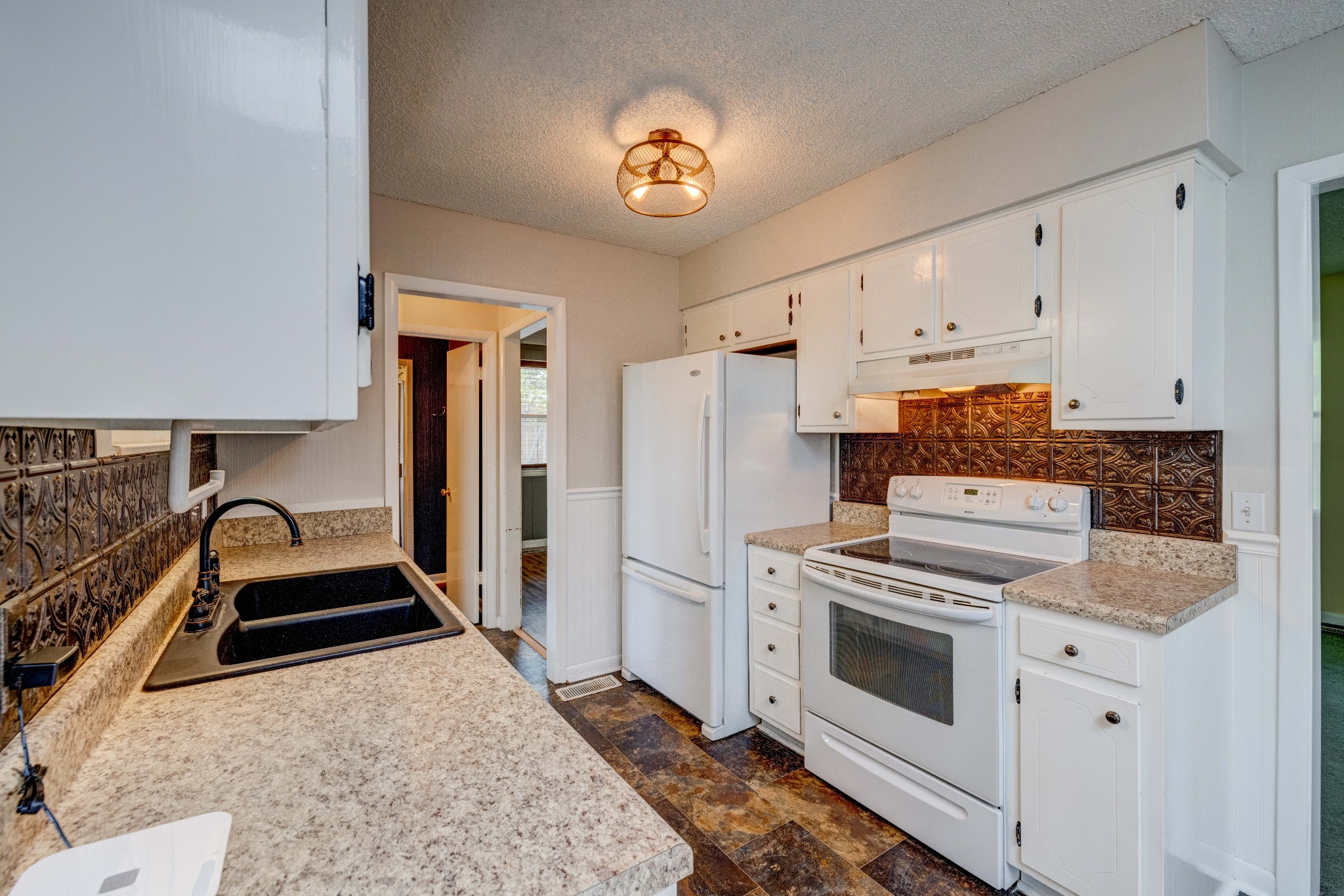 3312 Country Way Road Antioch, TN 37013 - Photo 9 of 35 a kitchen with a stove and white cabinets