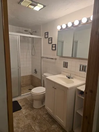 a bathroom with a sink toilet and shower