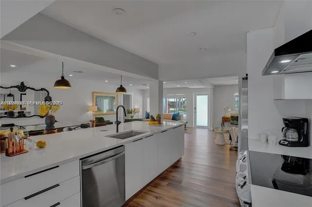 a kitchen with sink and wooden floor
