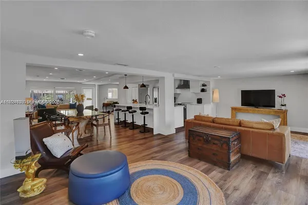 a living room with furniture a wooden floor and a fireplace
