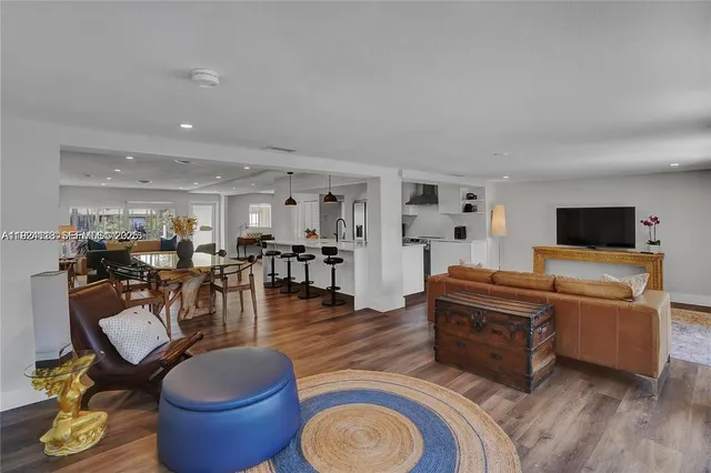 a living room with furniture a wooden floor and a fireplace