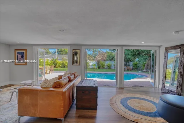 a living room with furniture and a floor to ceiling window