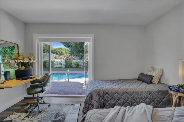 a bedroom with a bed and a desk