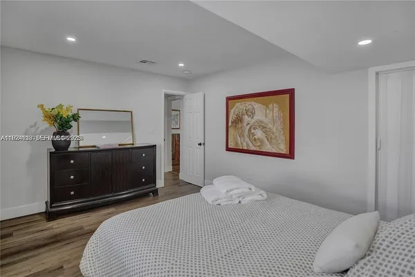 a bedroom with a bed and a dresser