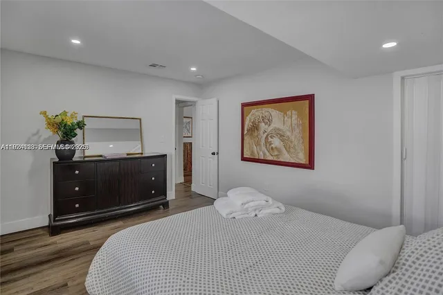 a bedroom with a bed and a dresser