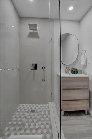 a bathroom with a mirror and a shower