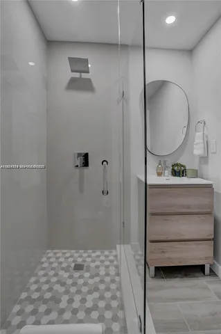 a bathroom with a mirror and a shower