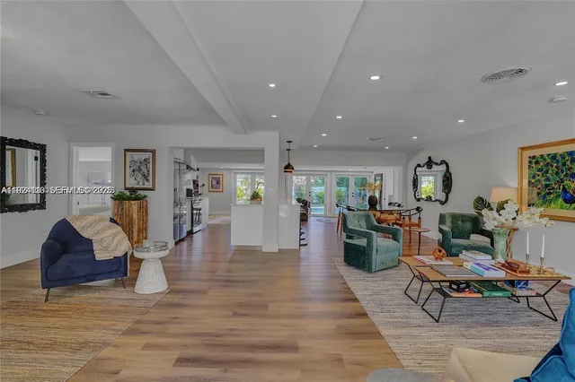 a living room with furniture and wooden floor