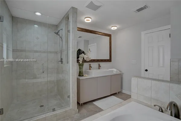 a bathroom with a bathtub and a shower