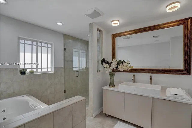 a bathroom with a bathtub sink and mirror