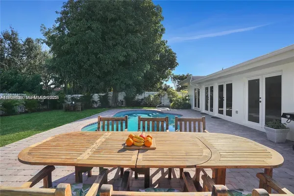 a view of a patio with a table and chairs
