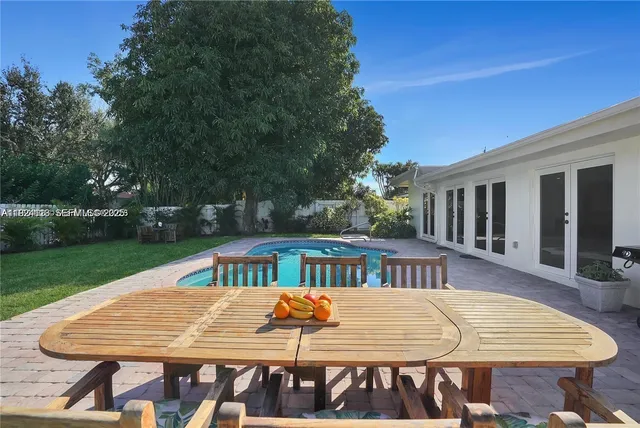 a view of a patio with a table and chairs
