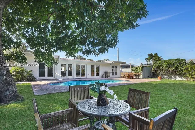 a house view with a seating space and garden