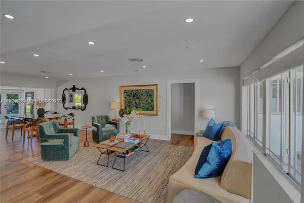 a living room with furniture and wooden floor