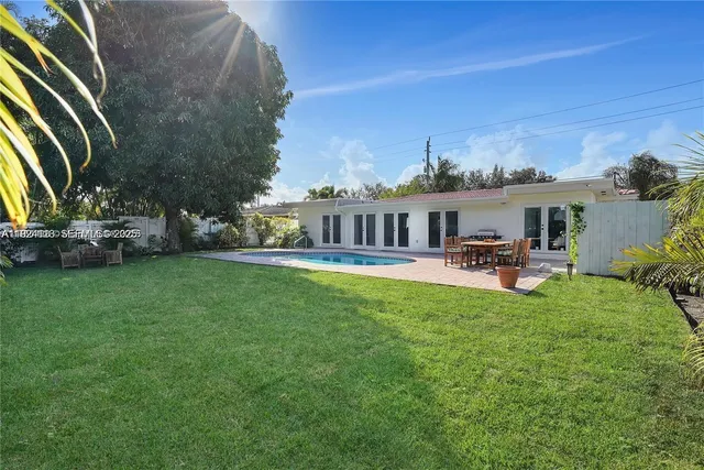 a view of a house with a backyard porch and sitting area