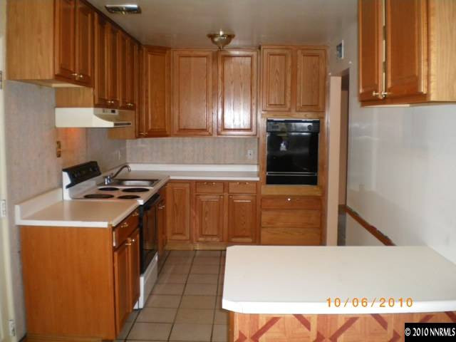 1701 Radcliffe Drive Reno, NV 89502 - Photo 2 of 7 a kitchen with stainless steel appliances granite countertop a stove a refrigerator and a microwave