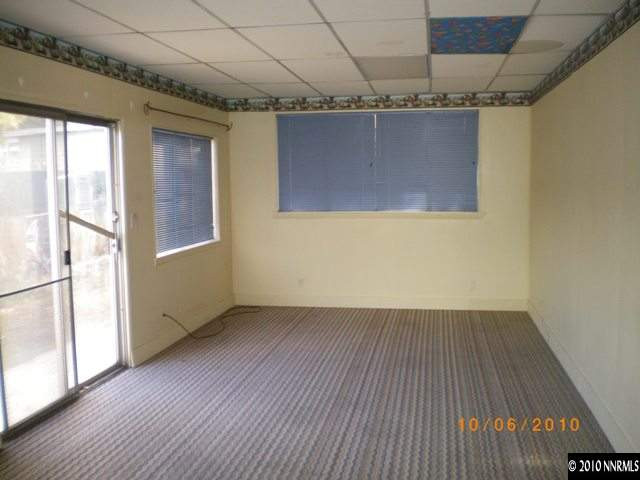 1701 Radcliffe Drive Reno, NV 89502 - Photo 6 of 7 an empty room with wooden floor and windows