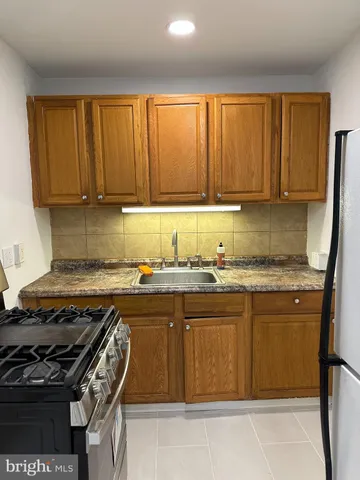 a kitchen that has a sink and a stove in it