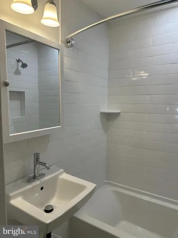 a bathroom with a sink and shower