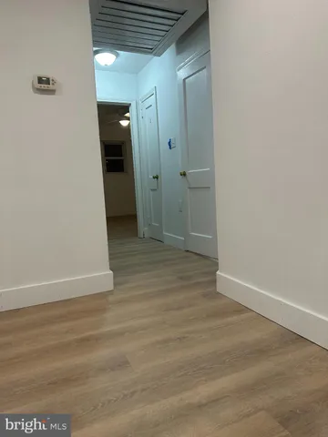 a view of hallway with wooden floor