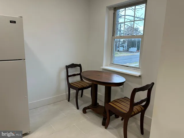 a view of a room that has a table and chair