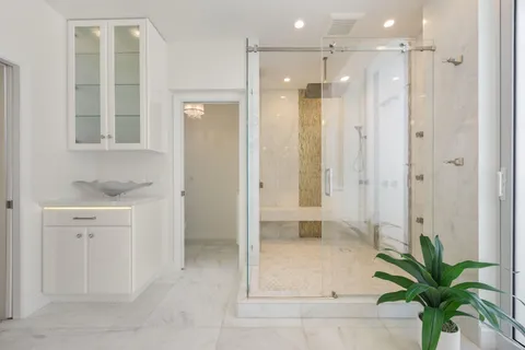 a bathroom with a shower sink and mirror